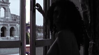 Tette alla finestra guardando il Colosseo