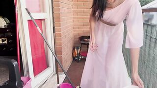 Casalinga pulisce il balcone con vestaglia trasparente